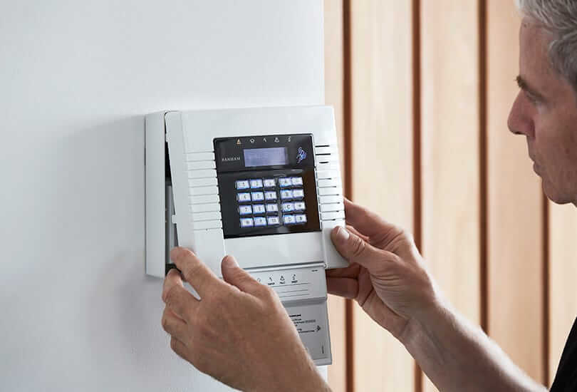 Banham Engineer Installing White Banham Alarm Panel